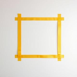 Painter’s tape marks on a wall for frame placement