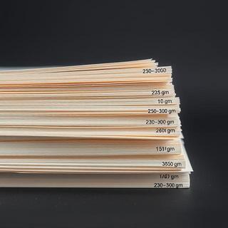 Stack of paper labeled 230gsm to 300gsm