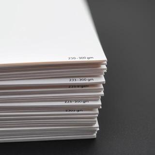Stack labeled 230–300 gsm