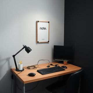 Workspace corner with a small note poster